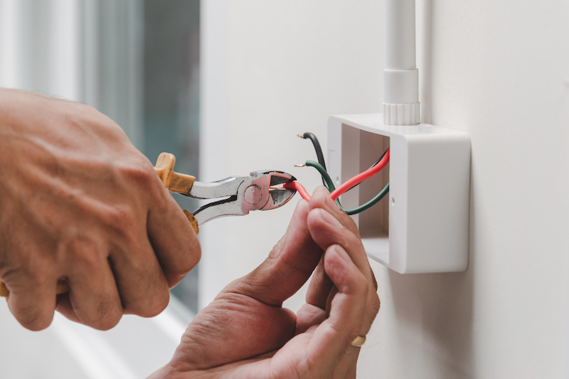 Professional electrician in Sandhurst installing new sockets.